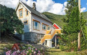an old house with stairs leading up to it at 3 Bedroom Nice Home In Valldal in Valldal