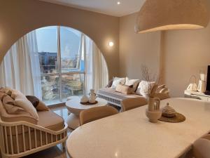 a living room with a couch and a large window at Stay Raum in Jakarta