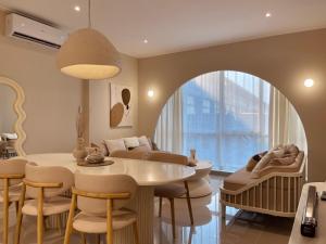 a living room with a table and chairs and a couch at Stay Raum in Jakarta