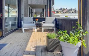 a patio with chairs and plants on a balcony at 2 Bedroom Gorgeous Apartment In Ålesund in Ålesund