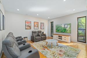 a living room with a couch and a table at Belle Escapes Villa Aurelia in Palm Cove