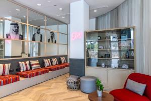 a store with couches and a red chair at Ink Hotel in Dubai