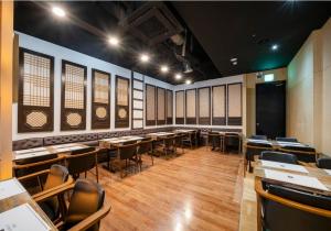 a room with tables and chairs in a room with windows at Starhills Hotel in Seoul