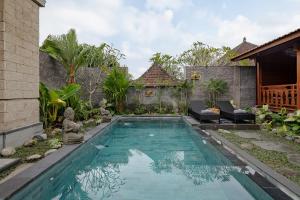 a swimming pool in the backyard of a house at Ithaca Ubud Villa in Ubud