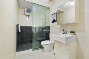 a bathroom with a toilet and a sink and a shower at Sovrae by Kozystay - Grogol in Jakarta +15 photos