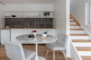 a dining room with a table and two chairs at The Local Studio - Byron Bay in Byron Bay +13 photos