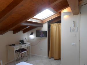 a room with a desk and a window with a laptop at Hotel Atlantic in Bologna