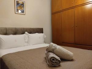 a bedroom with a large bed with a dresser at Linda's apartment in Agia Triada