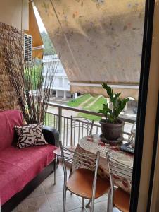 a living room with a table and a couch at Linda's apartment in Agia Triada