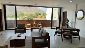 a living room with a couch and a table at Nabani Condominios T1 in Santa Cruz Huatulco