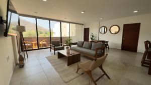 a living room with a couch and a table at Nabani Condominios T1 in Santa Cruz Huatulco