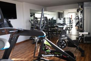 a gym with a bunch of tread machines in it at Hotel Yoru in Querétaro +4 photos
