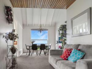 a living room with a couch and a table at Harbour View Oamaru in Oamaru