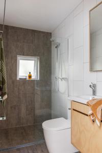 een badkamer met een douche, een toilet en een wastafel bij The Seaport Burleigh in Gold Coast