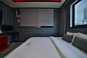 Postel nebo postele na pokoji v ubytování Hotel Danube Seomyeon