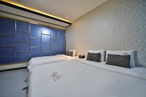 Postel nebo postele na pokoji v ubytování Hotel Danube Seomyeon