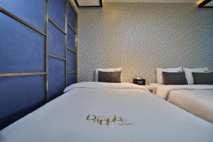 Postel nebo postele na pokoji v ubytování Hotel Danube Seomyeon