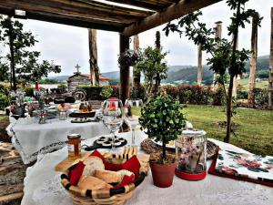 a table with food and wine glasses on it at Casa da Loura - Costa da Morte in Dumbría