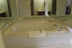 a bath tub with a towel in a bathroom at Deerfield Inn in Adamsville