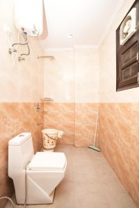 a bathroom with a toilet and a shower at Prince Villa in Gurgaon