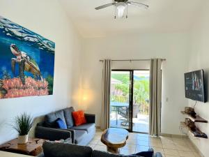 a living room with a couch and a table at Coral Reef Condo in Coco
