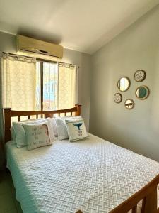 a bedroom with a bed with two pillows on it at Happy Oasis Second Floor Condo With Terrace in Coco +27 photos