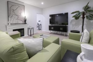 a living room with a couch and a tv at CBD Apartments by the International in Wagga Wagga