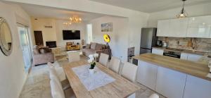 a kitchen and a dining room with a table and chairs at Villa Martina in Pinezici +59 photos