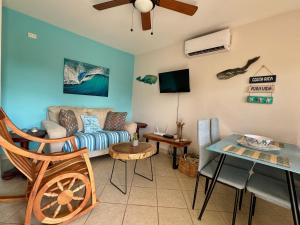 a living room with a couch and a table at High Tide 2 bed1 bath condo Terrace in Coco
