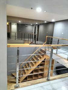a staircase in a room with at nice apartment with city view at Grand Jati Junction in Medan