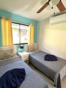 a bedroom with two beds and a window at High Tide 2 Bed1 Bath Condo Terrace in Coco +43 photos