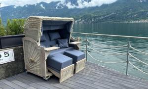 a chair sitting on the deck of a boat at Al Molo 5 - Lake Front in Oliveto Lario
