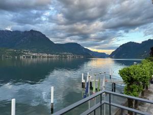 a dock on a lake with mountains in the background at Al Molo 5 - Lake Front in Oliveto Lario