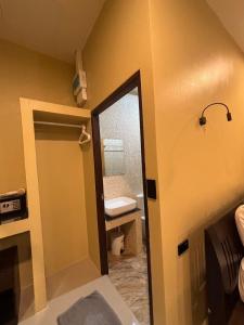 a bathroom with a mirror and a sink and a toilet at Serene Lanta Resort in Ko Lanta