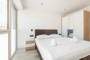 1 dormitorio con 1 cama blanca grande con almohadas blancas en Haus Wieser en Kaprun