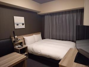 Posteľ alebo postele v izbe v ubytovaní Hotel Route-Inn Yamanashi Chuo