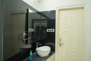 a bathroom with a sink and a mirror at N Cube Serviced Apartments in Hyderabad +30 photos