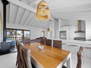 a dining room with a wooden table and chairs at Relaxing Getaway Beachfront Access Multi Family Pets Mandurah in Mandurah