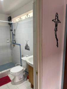 a bathroom with a toilet and a sink at VitaminSea Room in Dauin +17 photos