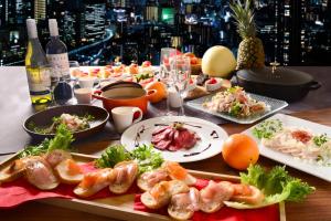 a table with plates of food on a table at Hotel Keihan Universal Tower in Osaka