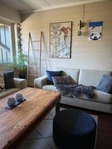 ein Wohnzimmer mit einem Sofa und einem Holztisch in der Unterkunft Storehorn Apartments in Hemsedal