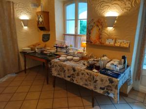 una mesa con comida en una habitación en Kräuterhotel Villa Vontenie en Kordel