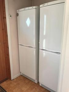 two white refrigerators sitting next to each other in a room at Vaxholm Skarpö archipelago island living with car access in Vaxholm