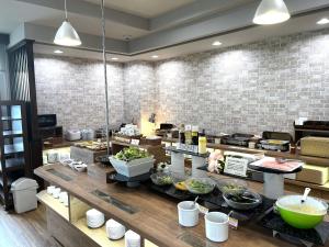 a kitchen with a counter with food on it at Hotel Route-Inn Gifukencho Minami in Gifu