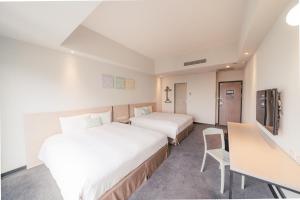 Postel nebo postele na pokoji v ubytování Hotel Liyaou