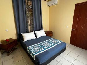 A bed or beds in a room at Studio Vanira, Tahaa, Haamene