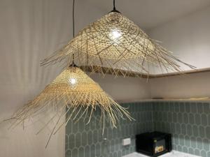 two lights hanging from the ceiling in a kitchen at The Urban Westlake Apartment in Hanoi
