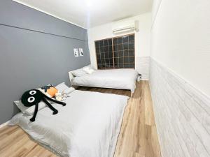 Postel nebo postele na pokoji v ubytování 高田馬場4分 最大7人 02