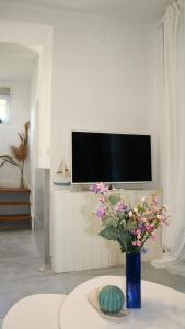 a living room with a vase with flowers on a table at Madarász 7 Deluxe Vendégház in Balatonalmádi