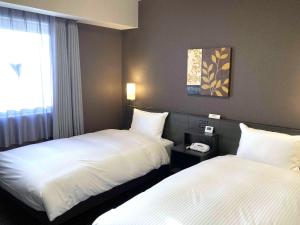 Postel nebo postele na pokoji v ubytování Hotel Route-Inn Kashima + 26 fotografií